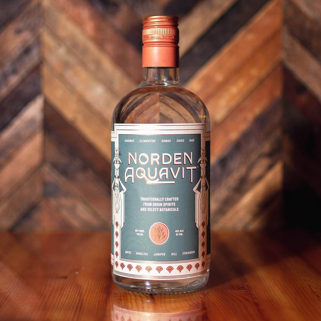 Bottle of Norden Aquavit on wooden table