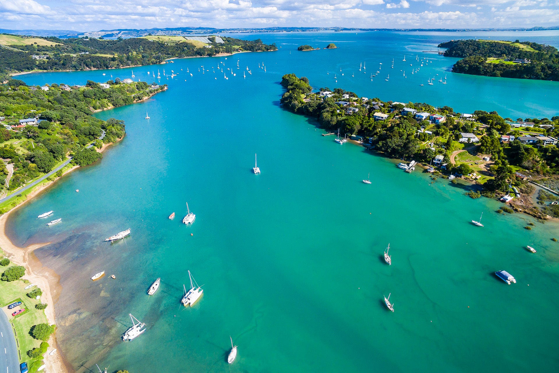 Overhead shot of a a bay with small boats anchored, turquoise blue water